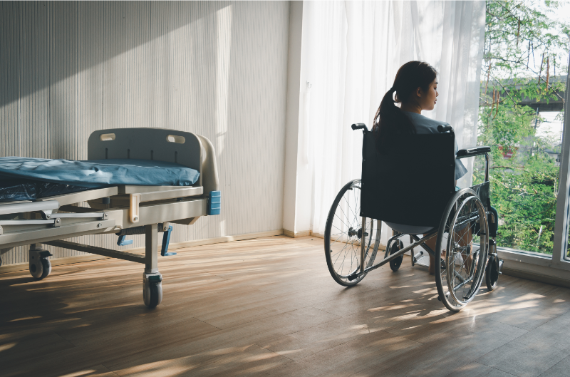 A sick woman looking outside the house